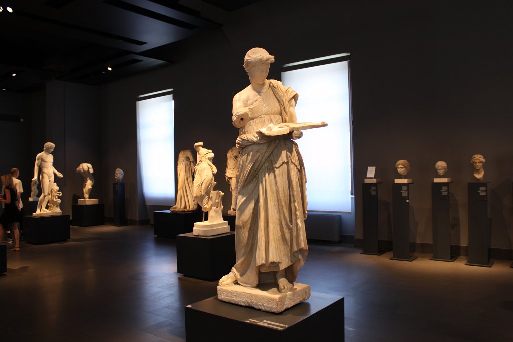 IMG_6735.JPG - Fanciulla d'Anzio (Maiden of Antium). The statue is thought to portray a girl participating in an open-air Dionysiac ritual shown as she turns her head towards a tray for offerings resting on her arm. This beautifully executed sculpture was made by a Hellenistic workshop of the Asia Minor school, probably for dedication to Dionysus at a sanctuary. The work was re-used in the furnishing of the Imperial villa for decorative purposes. Ca. mid-3rd century B.C.  National Museum of Rome - Palazzo Massimo alle Terme 