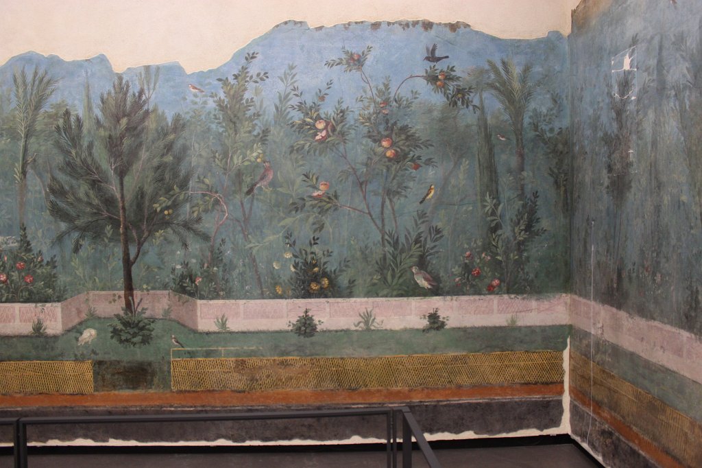 IMG_6765.JPG -  Triclinium of Livia .  In the triclinium of Livia, decorated with plants and birds like a flourishing garden, everything changed tonalities in relation to the change of natural light. In order to see the frescoes in the conditions of the original setting, a sophisticated system of biodynamic light has been installed, reproducing the change of the sunlight 'colour' during the day (after the sunset the light is kept on a mean value). The entire day cycle is reproduced in the space of few seconds at the beginning of each hour in order to emphasize the variations of the diurnal light.  National Museum of Rome - Palazzo Massimo alle Terme 